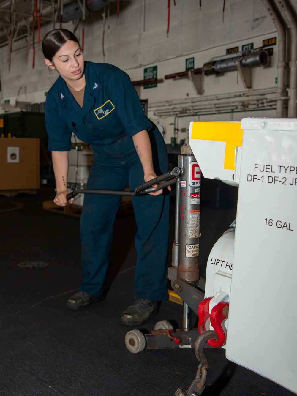 Nimitz Sailor Raises A Towing Tractor