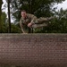 1st Lt.  Michael Vigh jumps over a wall