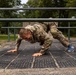 Sgt. Thomas Doles crawls under an obstacle