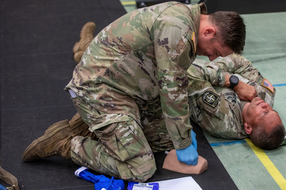 Sgt. 1st Class Benjamin Latham provides Tactical Combat Casualty Care