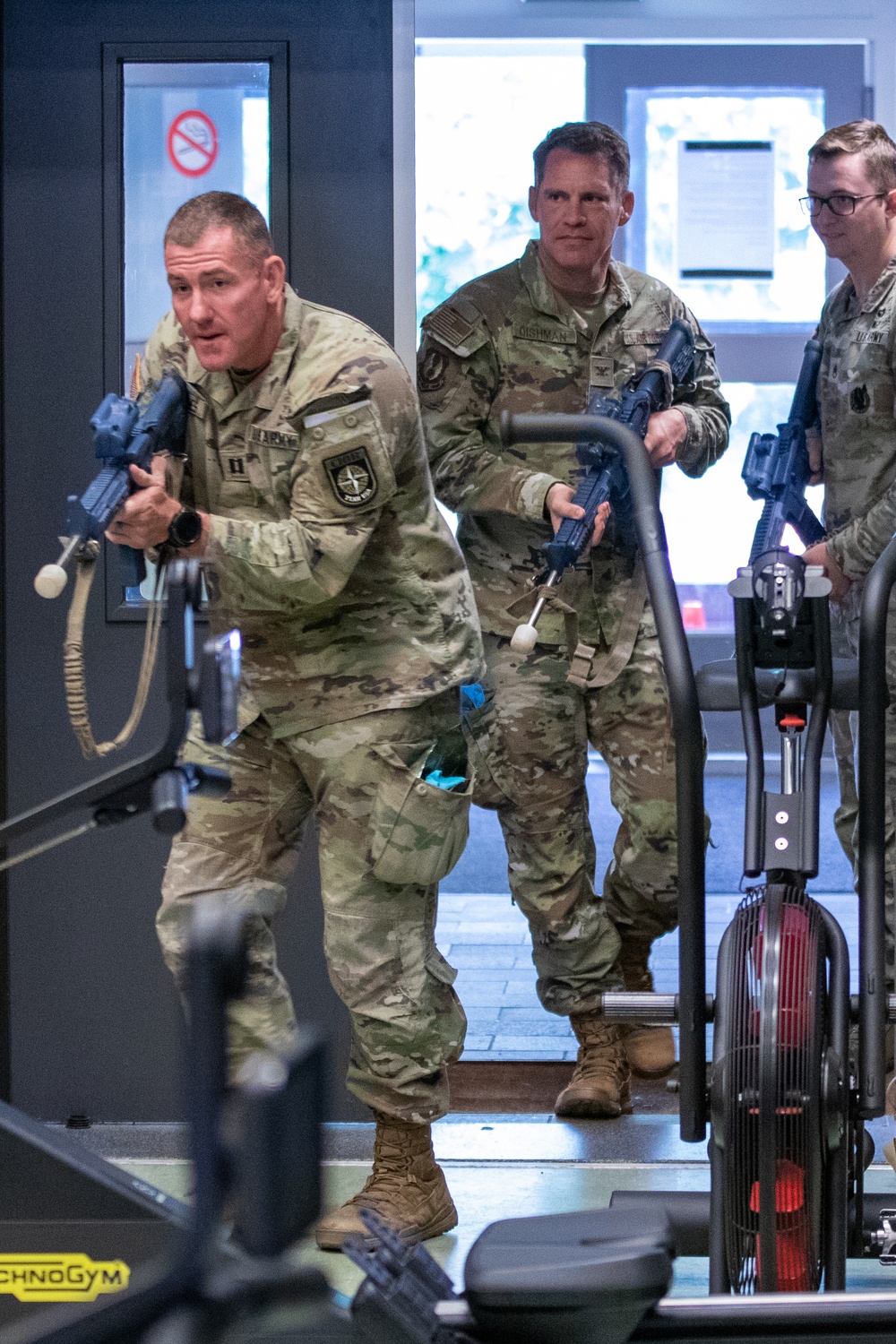 A U.S. CIOR MILCIMP team tactically moves through a doorway