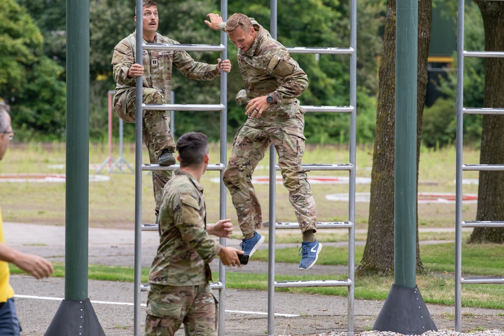 A U.S. CIOR MILCOMP team climbs a ladder