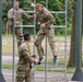 A U.S. CIOR MILCOMP team climbs a ladder