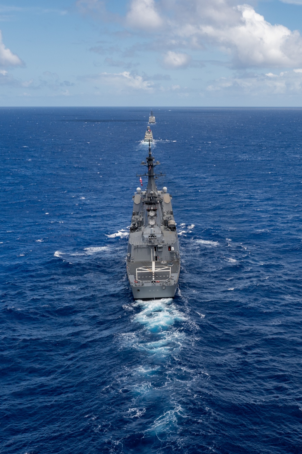 Multinational ships sail in formation during RIMPAC 2024