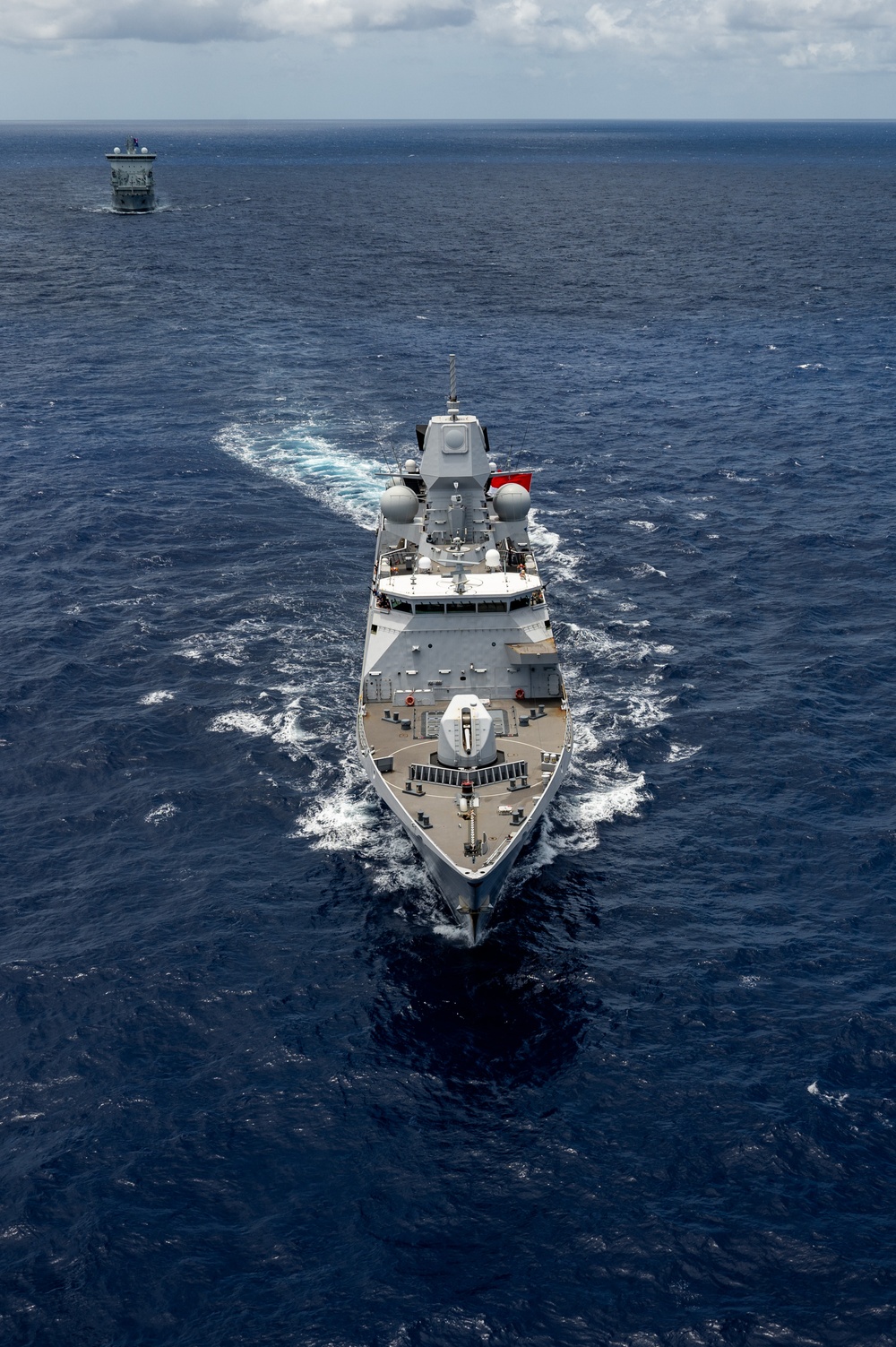 Multinational ships sail in formation during RIMPAC 2024