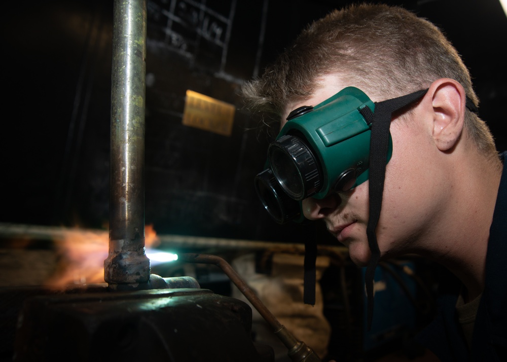 Nimitz Sailor Brazes A Pipe