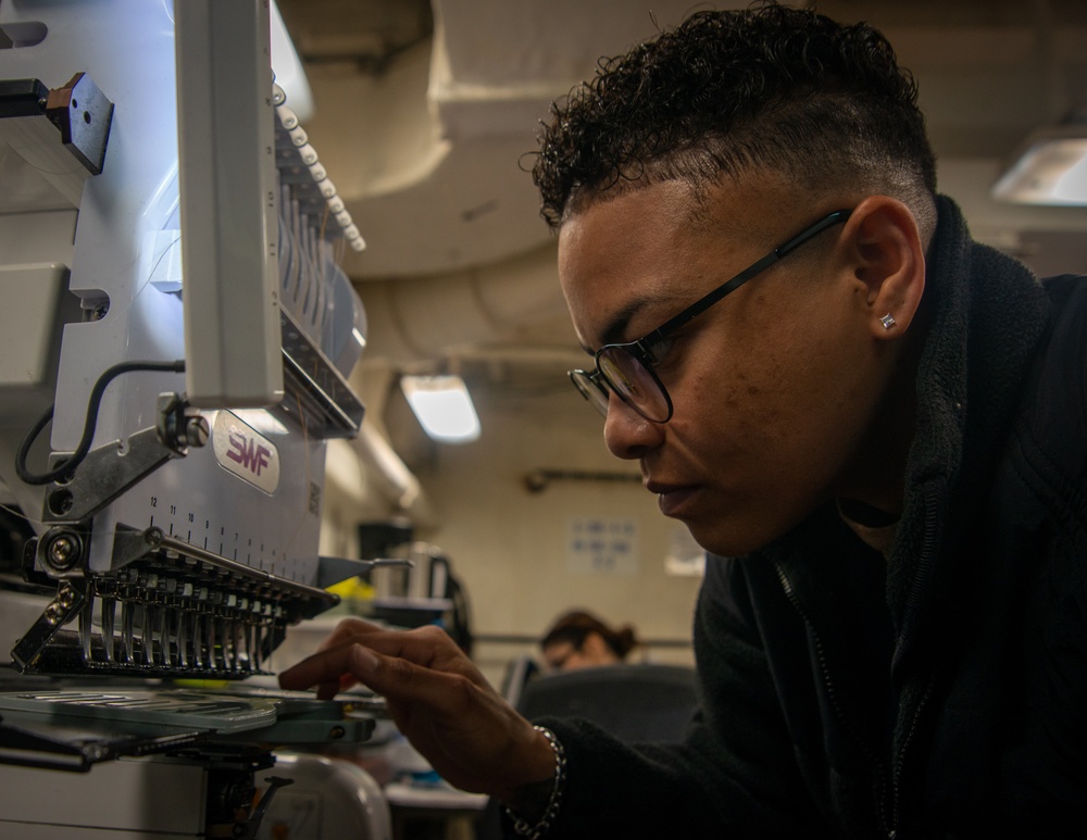 Nimitz Sailor Prepares To Sew A Name Patch