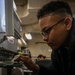 Nimitz Sailor Prepares To Sew A Name Patch