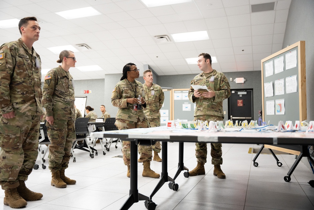 Specialist Robert Womack briefs Deputy Commanding General Cindy M. Saladin-Muhammad at Fort Knox, Kentucky July 25, 2024