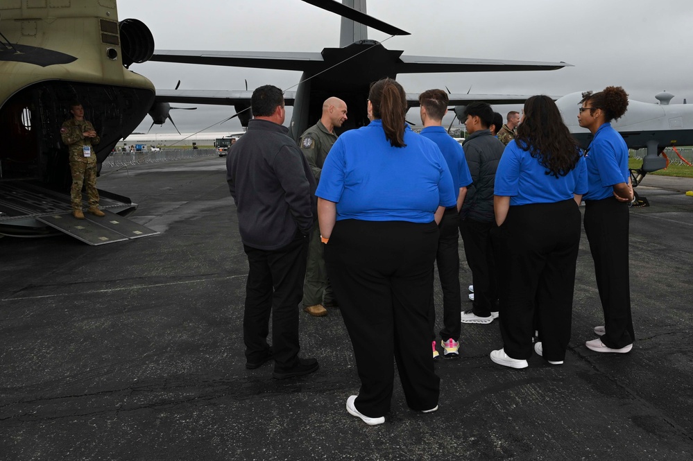 Military members talk with visiting rocketeer teams during FIA 2024