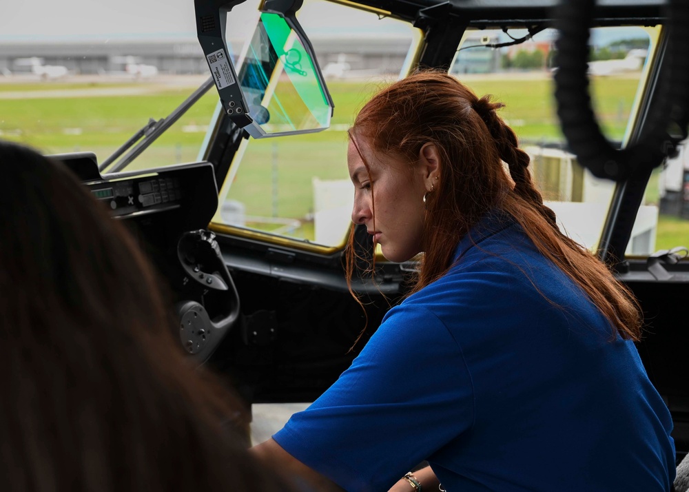 Military members talk with visiting rocketeer teams during FIA 2024