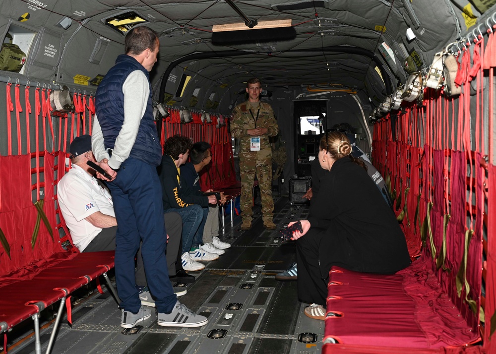 Military members talk with visiting rocketeer teams during FIA 2024