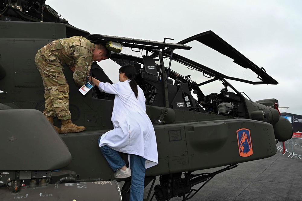 Military members talk with visiting rocketeer teams during FIA 2024