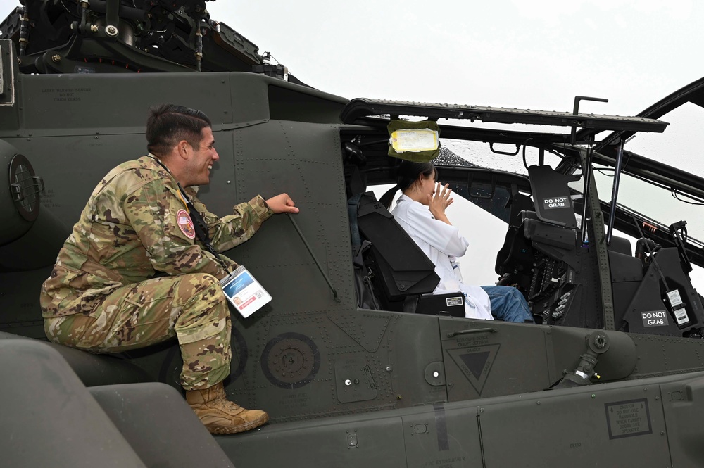 Military members talk with visiting rocketeer teams during FIA 2024