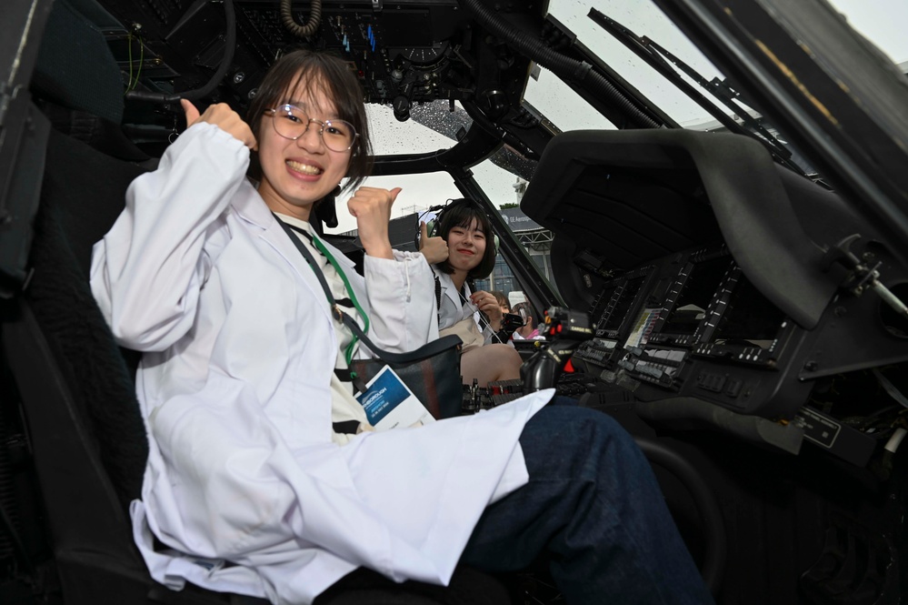 Military members talk with visiting rocketeer teams during FIA 2024