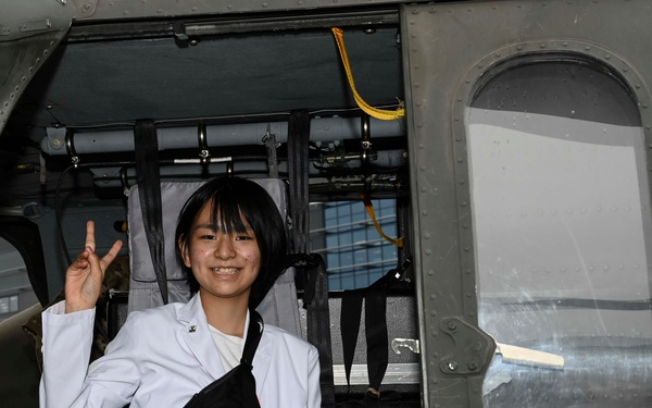 Military members talk with visiting rocketeer teams during FIA 2024