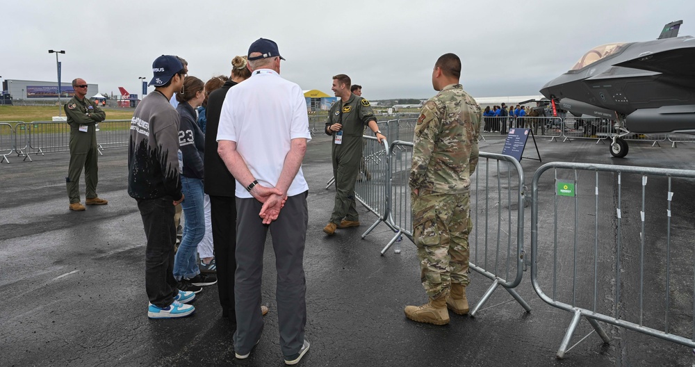 Military members talk with visiting rocketeer teams during FIA 2024