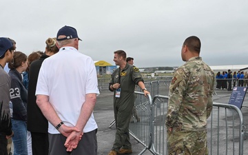 Military members talk with visiting rocketeer teams during FIA 2024