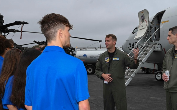 Military members talk with visiting rocketeer teams during FIA 2024