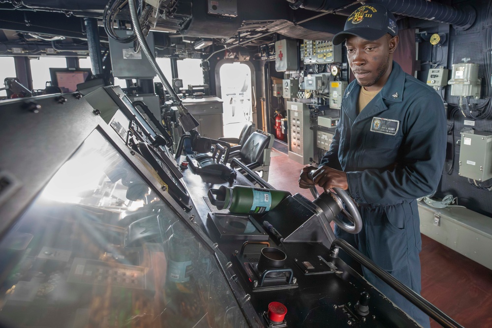 USS Spruance Sailor stands watch