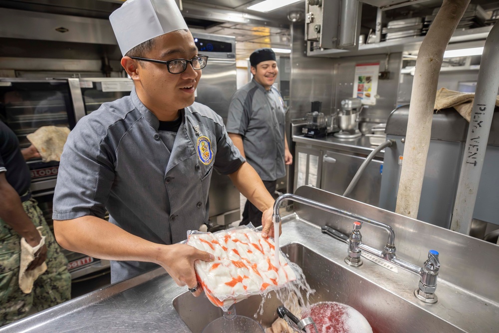 USS Spruance Sailor prepares food for dinner