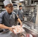 USS Spruance Sailor prepares food for dinner