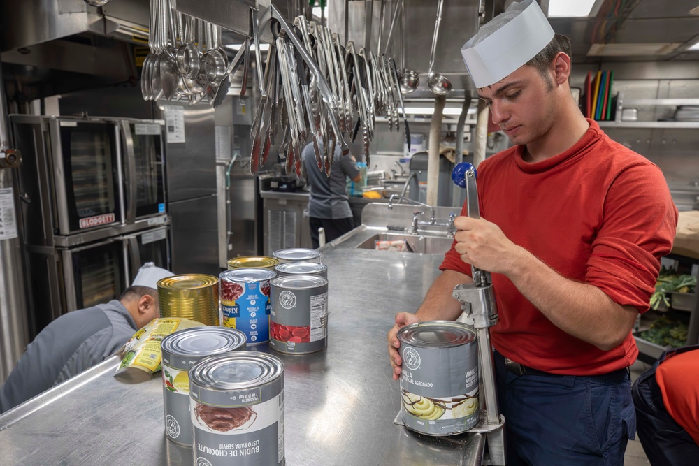 USS Spruance Sailor prepares food for dinner