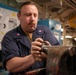 A Nimitz Sailor Attaches Gear To Stanchion Shaft