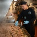 A Nimitz Sailor Grills Chicken