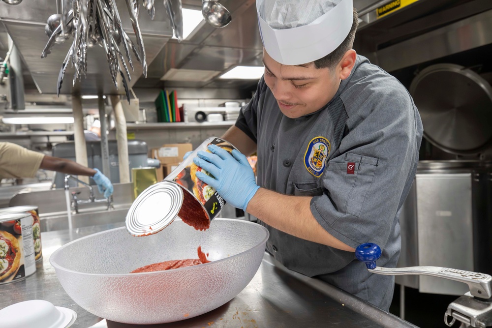 USS Spruance Sailor prepares food for dinner