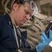 USS Tripoli Sailor Inspects oil