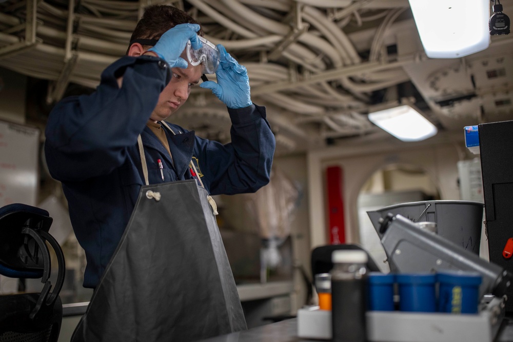 USS Tripoli Sailor Inspects oil