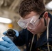 USS Tripoli Sailor Inspects oil