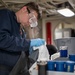 USS Tripoli Sailor Inspects oil