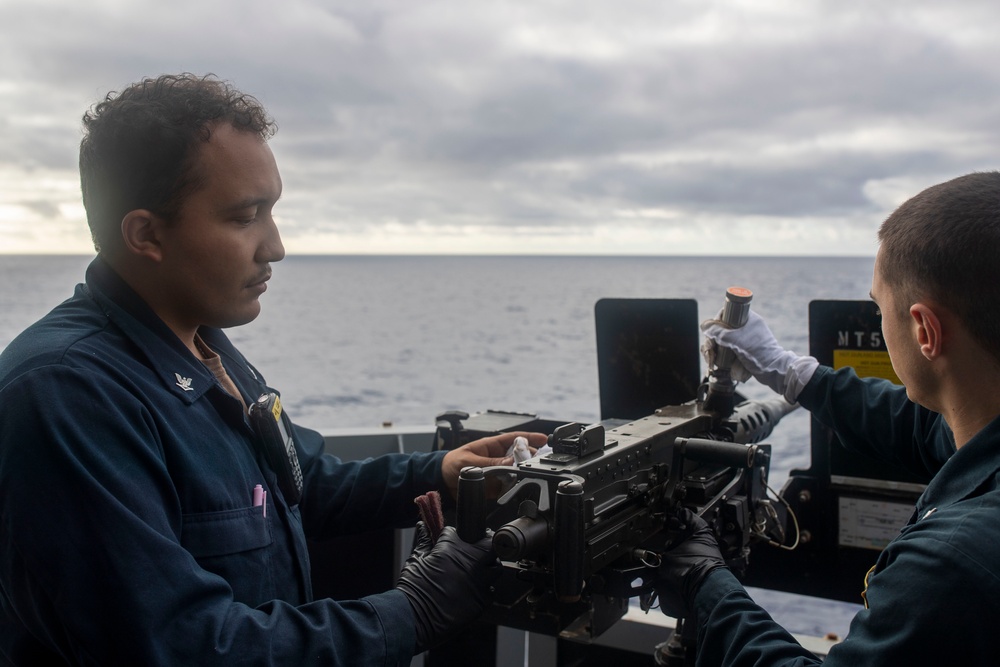 USS Tripoli Sailors Clean M2HB .50-caliber machine gun