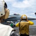 Members of the Royal Australian Navy watch flight operations aboard Nimitz-class aircraft carrier USS Carl Vinson (CVN 70) .
