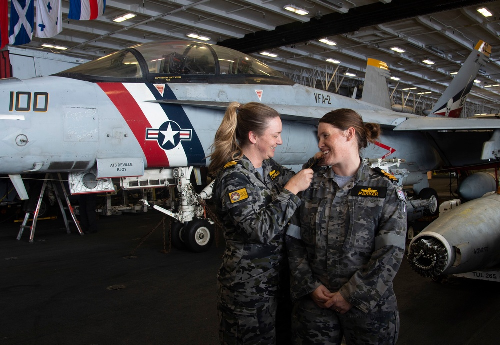 Royal Australian Navy Lt. Cmdr. Eve Parker promotes to the rank of commander aboard Nimitz-class aircraft carrier USS Carl Vinson (CVN 70).