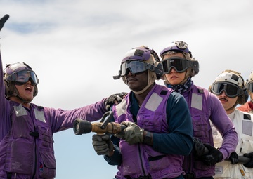 USS Somerset Sailor signals to scene leader during drill