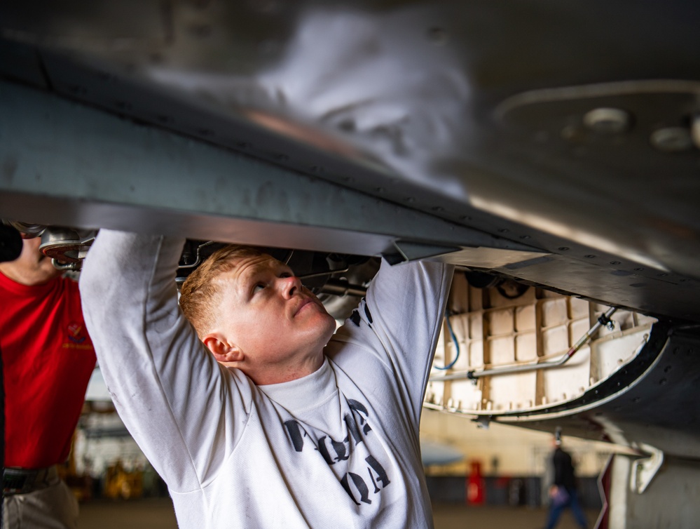 Nimitz Sailor Conducts Maintenance On F-18 Super Hornet