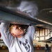 Nimitz Sailor Conducts Maintenance On F-18 Super Hornet