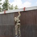 Sgt. Thomas Doles maneuvers off an obstacle