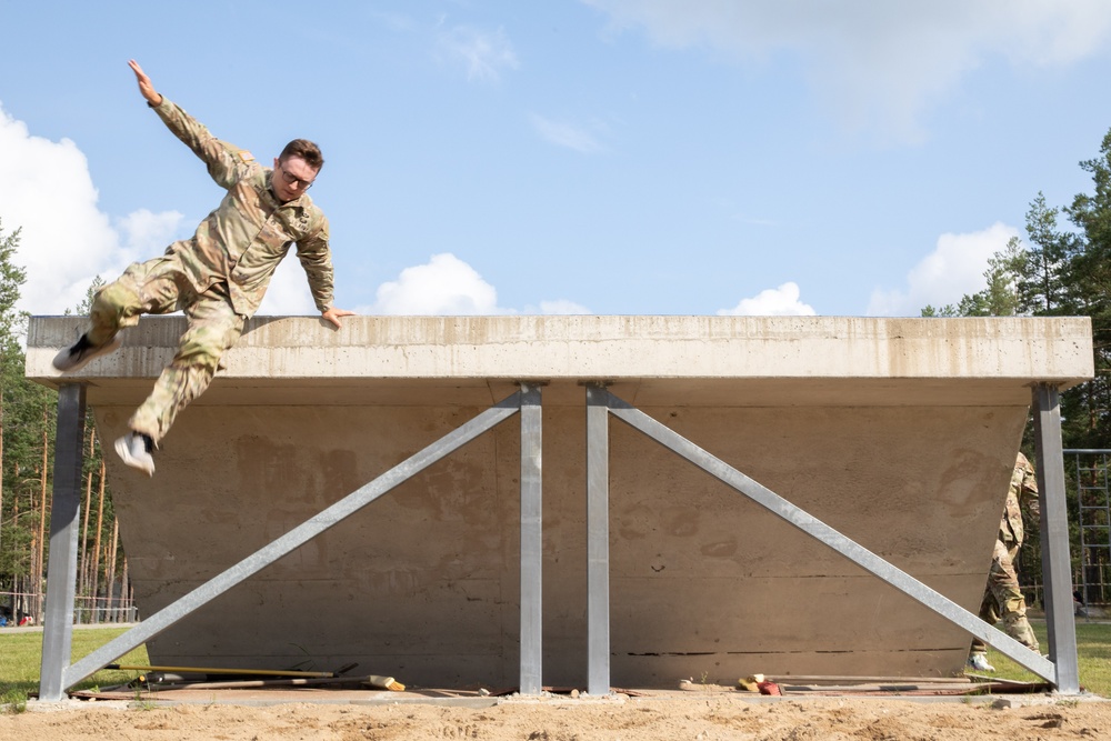 Staff Sgt. Zachary Mills maneuvers over an obstacle