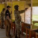 Sgt. 1st Class Kristoffer Friend assists