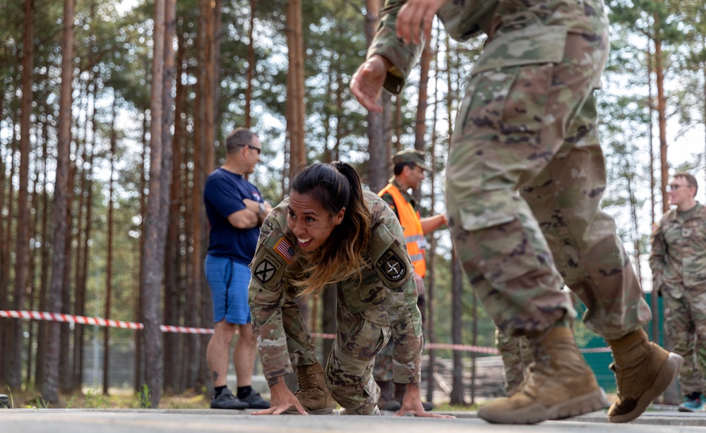 1st Lt. Jessica Romero climbs from an obstacle