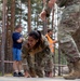 1st Lt. Jessica Romero climbs from an obstacle