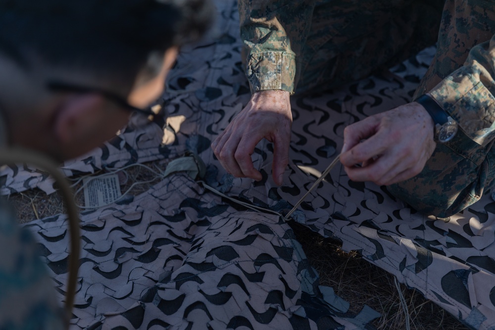 MRF-D 24.3: CLB-5 (Rein.) Sailors apply camouflage netting to a role 2 field hospital