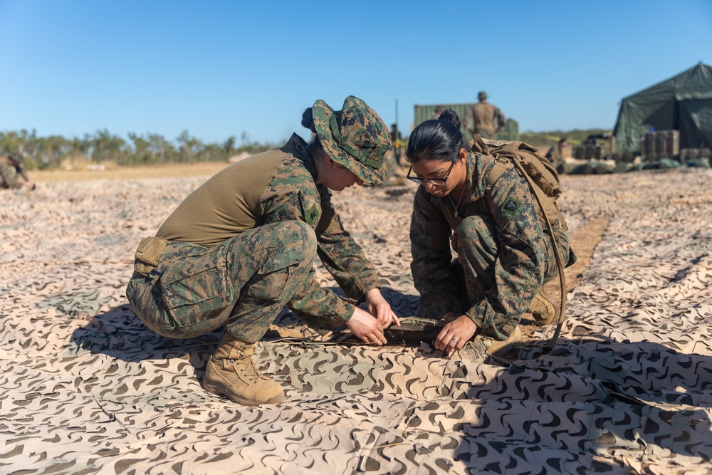 MRF-D 24.3: CLB-5 (Rein.) Sailors apply camouflage netting to a role 2 field hospital