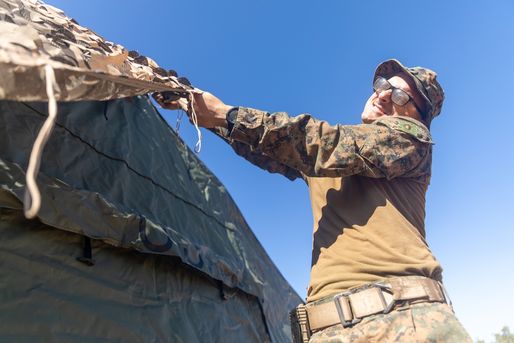 MRF-D 24.3: CLB-5 (Rein.) Sailors apply camouflage netting to a role 2 field hospital