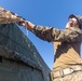 MRF-D 24.3: CLB-5 (Rein.) Sailors apply camouflage netting to a role 2 field hospital
