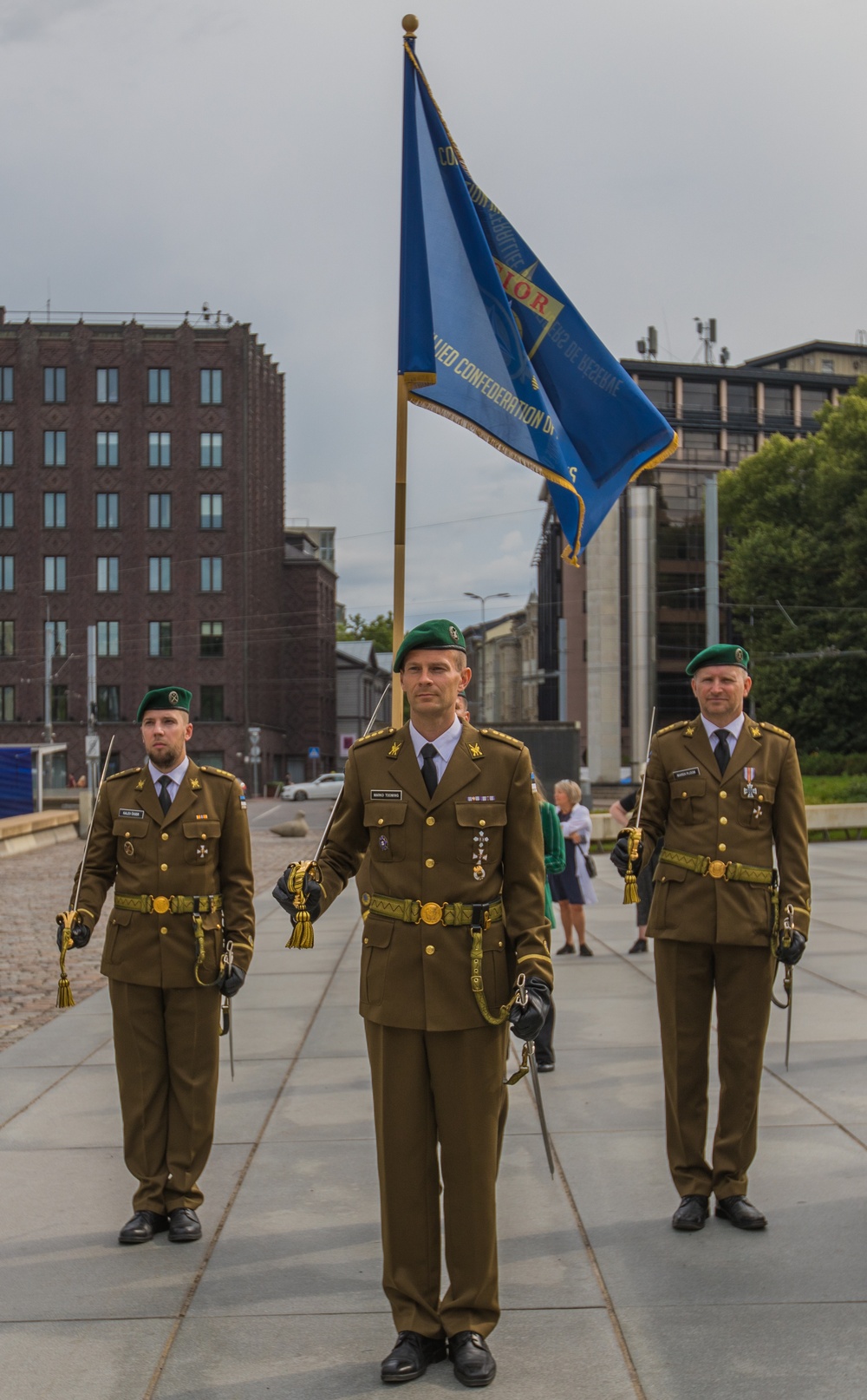 Service members representing Estonia carry the CIOR flag